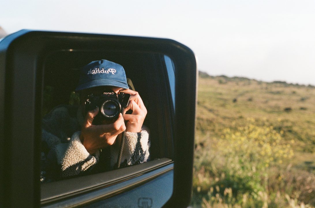 Colin shooting film through the car window