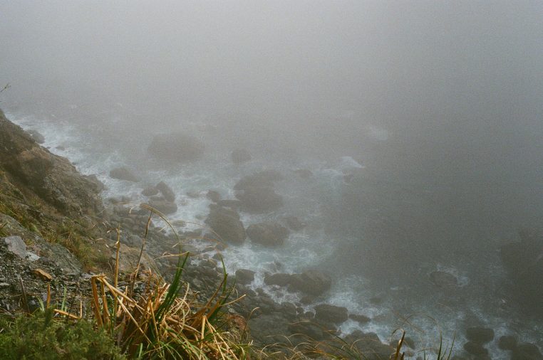 Surf breaking on the rocks below the highway